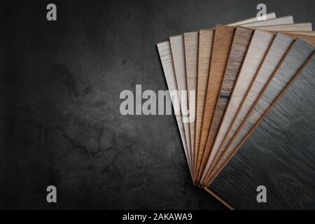 wood texture laminate material samples on black stone background with copy space Stock Photo