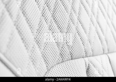 Modern luxury Car white leather interior. Part of perforated leather car seat details. White Perforated leather texture background. Texture, artificia Stock Photo