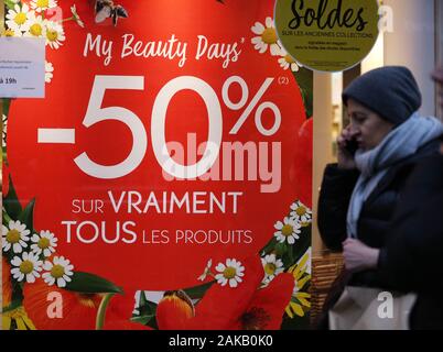 Paris, Jan. 8. 4th Feb, 2020. A woman walks past a poster displaying sales information in Paris, France, Jan. 8, 2020. Winter sales in France kicked off on Wednesday and will last to Feb. 4, 2020. Credit: Gao Jing/Xinhua/Alamy Live News Stock Photo
