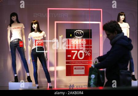 Paris, Jan. 8. 4th Feb, 2020. A man walks past a poster displaying sales information in Paris, France, Jan. 8, 2020. Winter sales in France kicked off on Wednesday and will last to Feb. 4, 2020. Credit: Gao Jing/Xinhua/Alamy Live News Stock Photo
