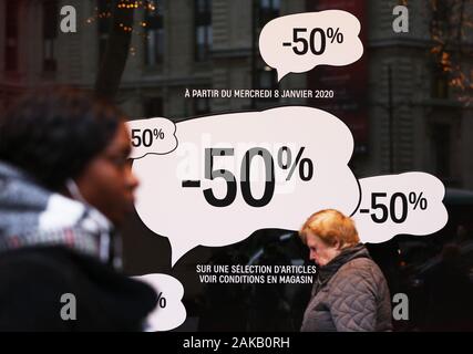Paris, Jan. 8. 4th Feb, 2020. People walk past posters displaying sales information in Paris, France, Jan. 8, 2020. Winter sales in France kicked off on Wednesday and will last to Feb. 4, 2020. Credit: Gao Jing/Xinhua/Alamy Live News Stock Photo