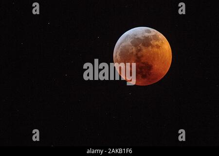 Full moon against black sky Stock Photo