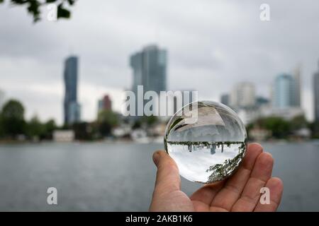 Skyline of the high buildings in 22nd district of Vienna, Austria as seen from alte Donau through glass ball Stock Photo