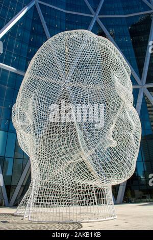 Big mesh head public art display in front of office tower Stock Photo
