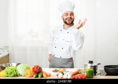 Perfect Taste. Professional Chef Man Gesturing With Hand Approving Recipe Smiling At Camera Standing In Kitchen. Selective Focus Stock Photo