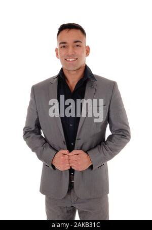 A handsome young man standing with his hands on his jacket  in a gray suit, isolated for white background Stock Photo