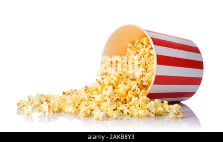 Scattered popcorn from paper striped bucket isolated on white background Stock Photo