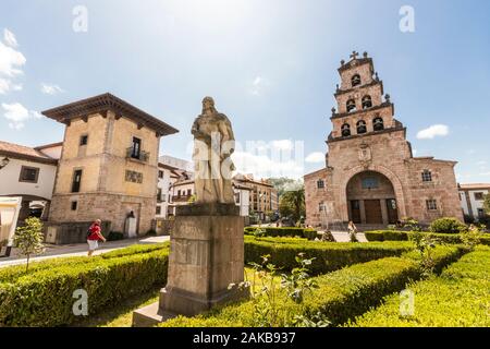 Cangas de Onis, Spain. The Iglesia de Santa Maria (St Mary's Church), with the monument to Don Pelayo (Pelagius of Asturias) in the foreground Stock Photo