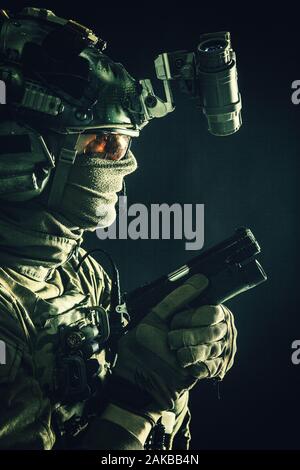 Elite commando soldier sneaking with pistol in hand Stock Photo