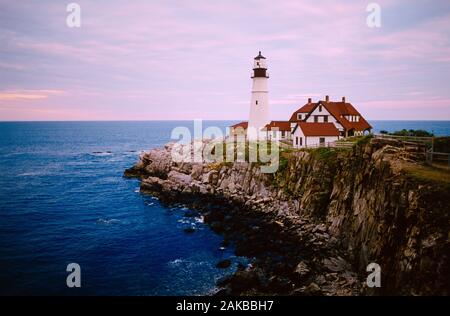 Portland Head Lighthouse and cliffs on seashore, Maine, USA Stock Photo