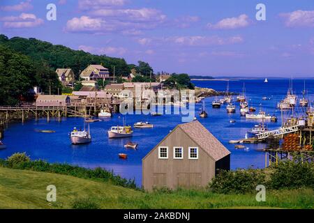 Coastal village of New Harbour with fishing boats and sailboats moored in harbor, Maine, USA