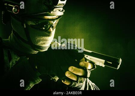 Police SWAT team fighter aiming service pistol Stock Photo