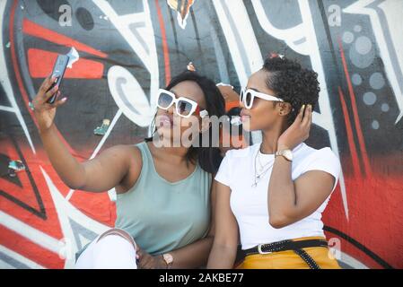 Two young women taking a selfie, Durban, South Africa Stock Photo
