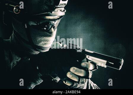 Police SWAT team fighter aiming service pistol Stock Photo