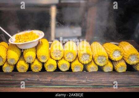 Steamed corn on the cob on display at Christmas market in winter wonderland of London Stock Photo