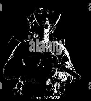 Modern army elite forces shooter in darkness Stock Photo