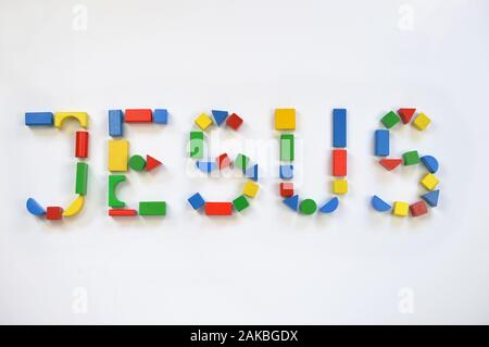 colorful wooden toy blocks lettering the name JESUS Stock Photo