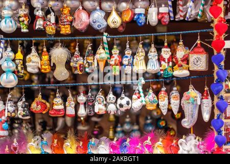 Christmas tree ornaments on display at Christmas market in winter wonderland of London Stock Photo