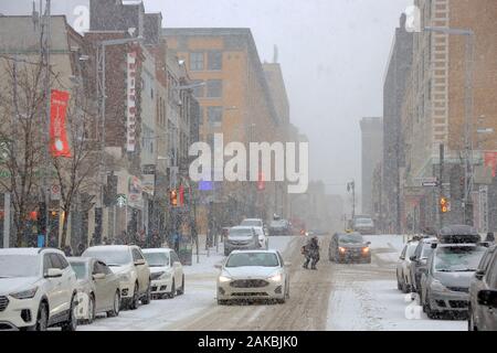 Rue Sainte-Catherine Ouest.St-Catherine street west.Downtown Montreal at a snowstorm day.Montreal.Quebec.Canada. Stock Photo