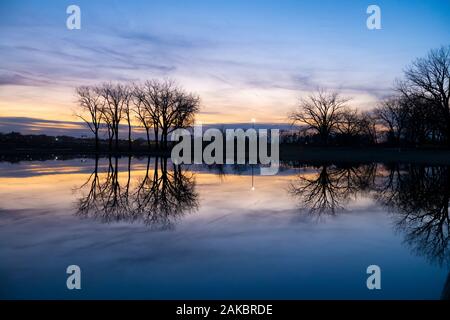 Sunset reflection on calm lake Stock Photo