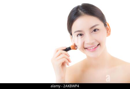 Beauty asian woman applying make up with brush isolated on white background, health clean skin concept. Stock Photo