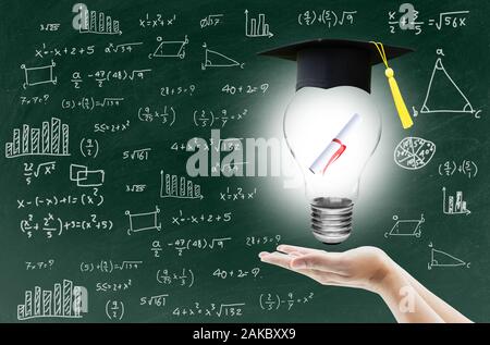 hand holding light bulb with certification for graduation shows the ingenuity intelligence knowledge and success for education on blackboard. Stock Photo