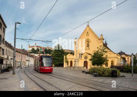 Slovakia, Bratislava, church of the Capuchins consecrated in 1717 and dedicated to Saint-Etienne of Hungary with on its forecourt a column erected in 1723 recalling the epidemic of plague and the tramway which passes in front Stock Photo