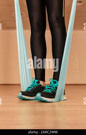 Stock photo of a young woman doing exercises with the resistance band