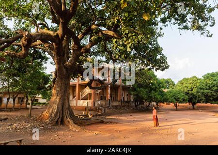 Benin, Abomey, woman standing in front of a colonial structure Stock Photo