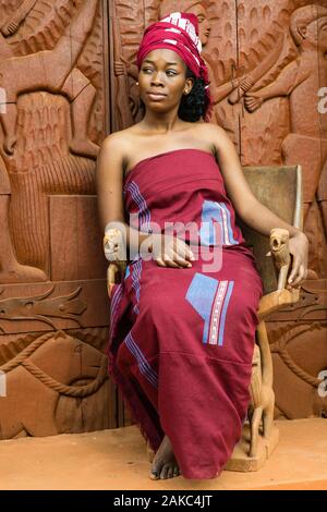 Benin, Abomey, woman in front of the door of Abomey museum Stock Photo