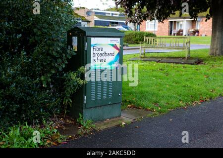 Woodbridge, UK October 18 2019. A green telecom cabinet advertising the release of fibre broadband in the area Stock Photo