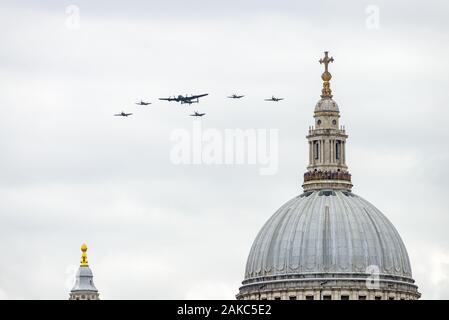 RAF Lancaster bomber in display formation with Spitfire fighters flying over St. Pauls cathedral on the RAF 100th anniversary, London, UK Stock Photo