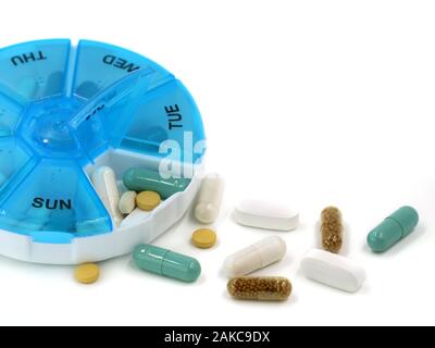 Close up of various pills in daily pill box on white background with copy space Stock Photo