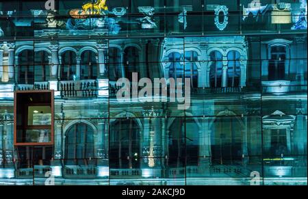 Reflection of an old building in the facade of a building made out of glass in Lyon France Stock Photo
