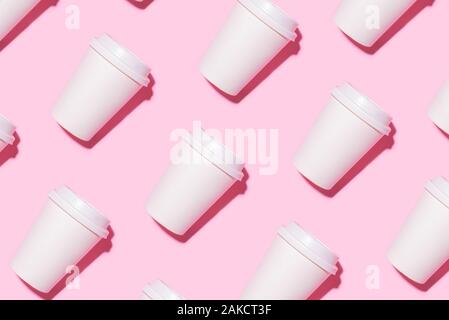 Pattern of disposable coffee cups on a pink background. Stock Photo