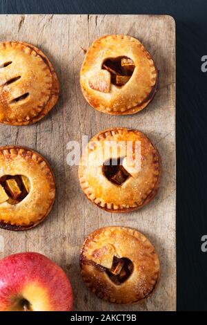 Food valentine idea concept fresh baked Homemade apple cinnamon hand pie on black background Stock Photo
