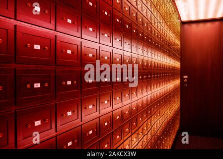 The safe room is a multi-colored room of illusions. The room is safe with a brown door. The room is illuminated by a multi-colored light. Stock Photo