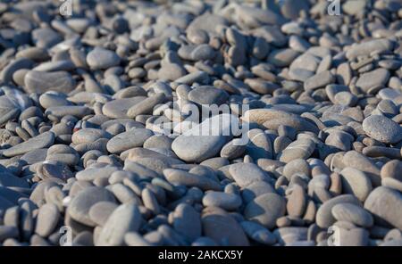 Rounded Pebble beach ground with blurred parts Stock Photo