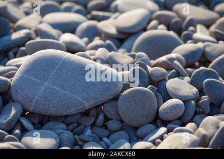 Rounded Pebble beach ground with blurred parts Stock Photo