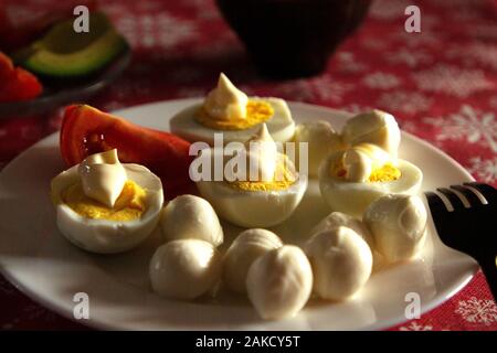Healthy ketogenic breakfast. Keto low-carb Boiled eggs with homemade mayonnaise and mozzarella. The best diet for the brain. Stock Photo