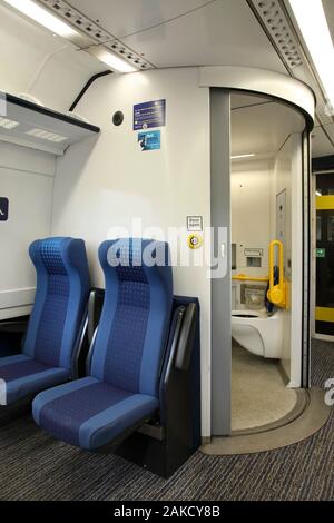 Wheelchair accessible toilet cubicle and seats inside Northern Rail Class 170 'Turbostar' diesel multiple unit train. York, UK. Stock Photo