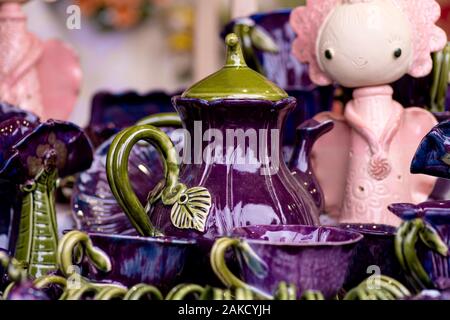 Glassware from a fairy tale. Ceramic tableware, multi-colored.Ceramic Designer Cups. Designer handmade dishes, plates and cups in a stylish boutique. Stock Photo