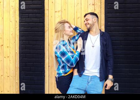 Fashion hipster in love couple holding one another while looking into each other's eyes Stock Photo
