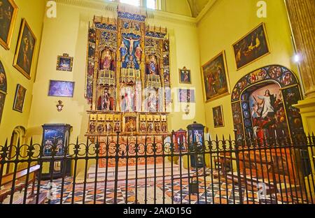MALAGA, SPAIN - SEPTEMBER 26, 2019:  The intricate carvings of Gothic altarpiece of St Barbara Chapel of Malaga Cathedral, on September 26 in Malaga Stock Photo