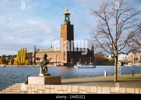 Scenic view of famous Stockholm city hall with Djurgarden ferry boat and Evert Taube statue, central Stockholm, Sweden, Scandinavia Stock Photo