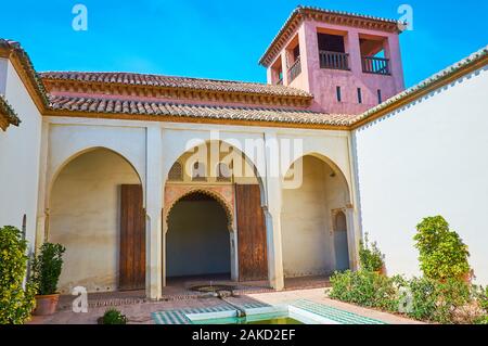 MALAGA, SPAIN - SEPTEMBER 26, 2019: Preserved Patio del Aljibe (Reservoir court) of the Nasrid Palace (Palacio Nazari) with small tower and fountain w Stock Photo