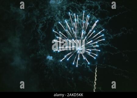 Turquoise, large fireworks a over the city. Stock Photo