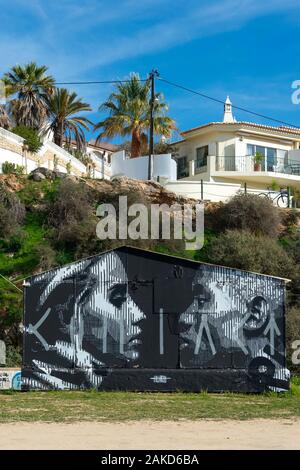 urban street art painted on a fishermans hut on the beach at Ferragudo, Portugal Stock Photo