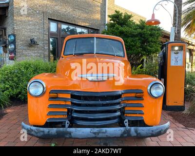 vintage old antique truck at gas station with cobblestone path front view Stock Photo