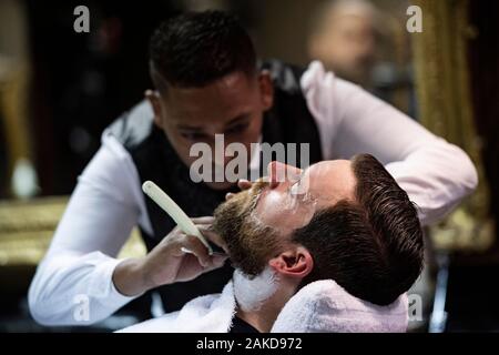 Hairdresser cutting beard, traditional barber shop, Mr Cobbs, Cape Town, South Africa Stock Photo